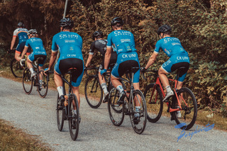 woman in black tank top and blue shorts wearing black helmet riding on red and black